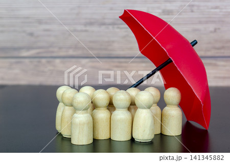Large umbrella sheltering large followers symbolizing strong leadership, safety, and organizational protection. 141345882