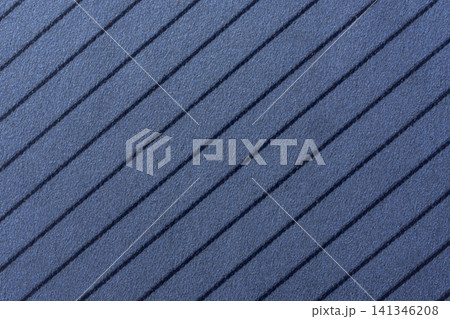 Background of a blue, textured surface featuring parallel, dark blue diagonal stripes. Background of a blue, textured surface featuring parallel, dark blue diagonal stripes. 141346208