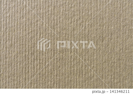 a textured, light brown cardboard surface. a textured, light brown cardboard surface. 141346211