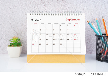 September 2027 Desk Calendar with wooden pencil on white table. September 2027 Desk Calendar with wooden pencil on white table. 141346612
