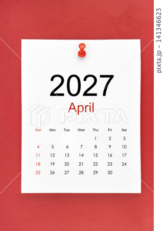 April 2027 calendar page with push pin on red color background. 141346623