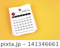 October 2027 calendar page with wooden push pin on yellow background. 141346661