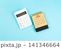 February 2027 brown caculator and white calculator on blue color background. 141346664