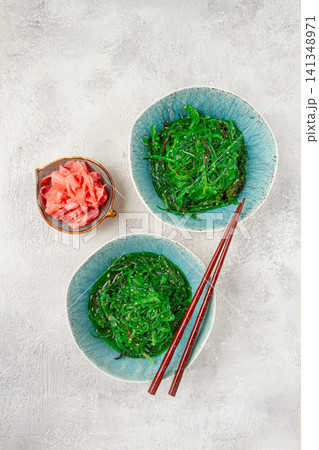 Chuka salad made from fresh seaweed, with sesame dressing, two bowls with chopsticks and pickled ginger, no people, Chuka salad made from fresh seaweed, with sesame dressing, two bowls with chopsticks and pickled ginger, no people, 141348971