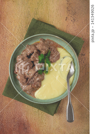 liver beef stroganoff with mashed potatoes, table setting in green tones, homemade, 141349026