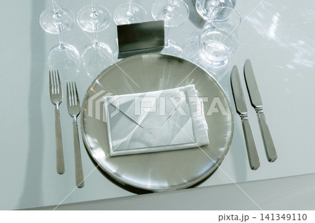 Restaurant table setting with plates cutlery and crystal glasses Restaurant table setting with plates cutlery and crystal glasses 141349110