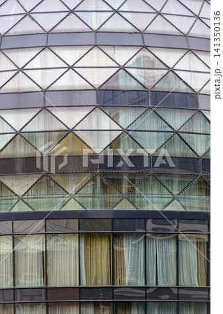 Modern glass building facade with geometric pattern Modern glass building facade with geometric pattern 141350136