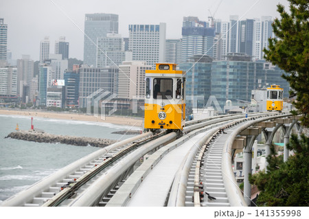 Tourists in yellow sky capsule on monorail by Haeundae beach, Busan 141355998