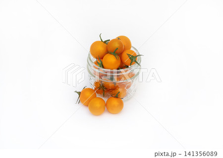 Jar of bright orange cherry tomatoes on the white background. Jar of bright orange cherry tomatoes on the white background. 141356089
