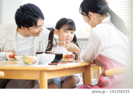 ファミリー　食事シーン　ほっぺにご飯粒を付けた女の子 141356535