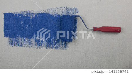 Paint Roller Applying Blue Paint on Textured Wall Paint Roller Applying Blue Paint on Textured Wall 141356741