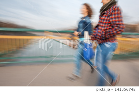 Motion Blur of People Walking on Urban Bridge 141356748