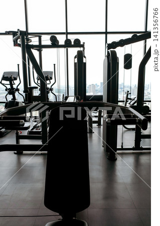 Modern Gym Equipment Silhouette with City View Modern Gym Equipment Silhouette with City View 141356766