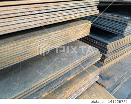 Steel Plates Stacked in Industrial Warehouse Steel Plates Stacked in Industrial Warehouse 141356773