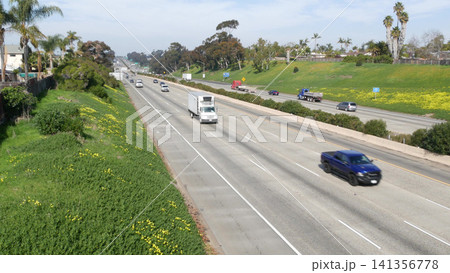 Highway Traffic on Sunny Suburban Freeway with Palm Trees Highway Traffic on Sunny Suburban Freeway with Palm Trees 141356778