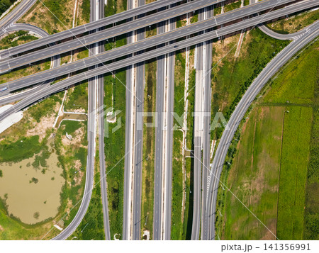 Drone shot a large highway interchange crossing over green farmlands in Thailand Drone shot a large highway interchange crossing over green farmlands in Thailand 141356991