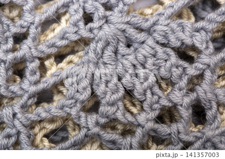 Background from a fragment of a garment knitted with cotton yarn Background from a fragment of a garment knitted with cotton yarn 141357003