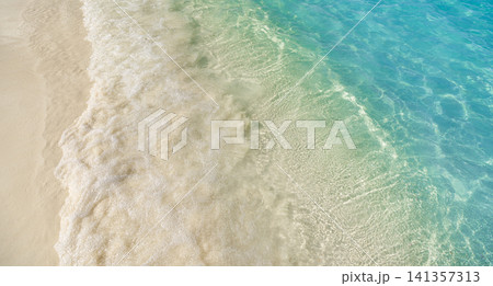 Crystal clear water flowing over rippled sand, transparent wave texture from above. Fresh green tinted sea washing tropical shore, natural abstract surface detail. Pure organic background for eco, spa Crystal clear water flowing over rippled sand, transparent wave texture from above. Fresh green tinted sea washing tropical shore, natural abstract surface detail. Pure organic background for eco, spa 141357313
