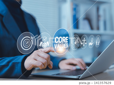 Core Values and Business Ethics Concept. A business professional interacts with digital icons on screen featuring CORE VALUES, representing integrity, trust, purpose, and corporate responsibility. Core Values and Business Ethics Concept. A business professional interacts with digital icons on screen featuring CORE VALUES, representing integrity, trust, purpose, and corporate responsibility. 141357629