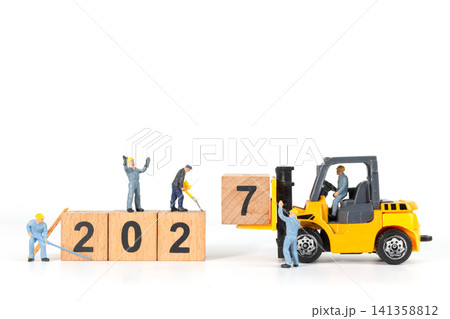 Miniature Workers and Forklift Changing Wooden Blocks from 2026 to 2027 New Year Concept Miniature Workers and Forklift Changing Wooden Blocks from 2026 to 2027 New Year Concept 141358812
