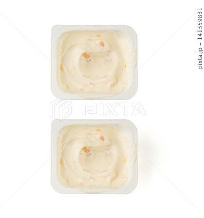 Yogurt cup isolated, yoghurt with orange fruits pieces in plastic pot, milk pudding container Yogurt cup isolated, yoghurt with orange fruits pieces in plastic pot, milk pudding container 141359831