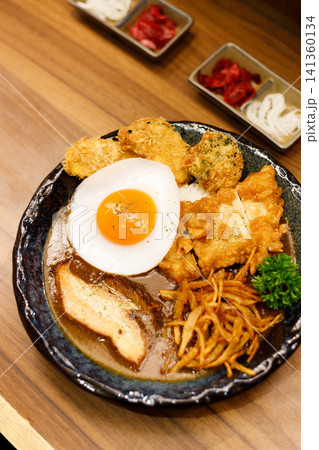 Japanese curry rice dish with thick and spiced sauce pairing with variety of meat. 141360134