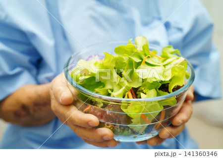 Asian elderly woman patient holding healthy food for patient in hospital, nutrition and vitamin. 141360346