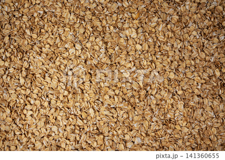 Oat flakes textured pattern, rolled oatmeal macro background Oat flakes textured pattern, rolled oatmeal macro background 141360655