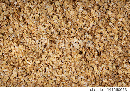 Oat flakes textured pattern, rolled oatmeal macro background Oat flakes textured pattern, rolled oatmeal macro background 141360658