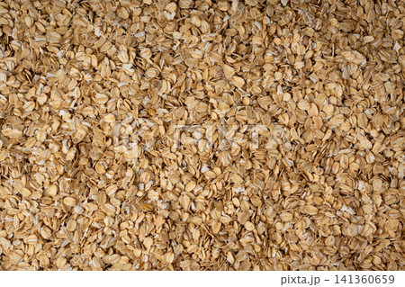 Oat flakes textured pattern, rolled oatmeal macro background 141360659
