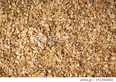 Oat flakes textured pattern, rolled oatmeal macro background Oat flakes textured pattern, rolled oatmeal macro background 141360660