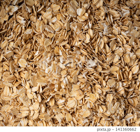 Oat flakes textured pattern, rolled oatmeal macro background Oat flakes textured pattern, rolled oatmeal macro background 141360662
