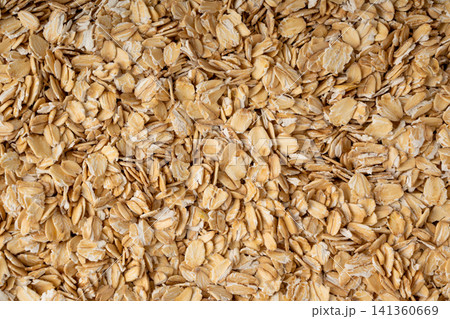 Oat flakes textured pattern, rolled oatmeal macro background Oat flakes textured pattern, rolled oatmeal macro background 141360669