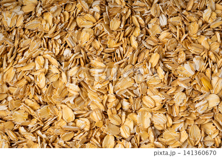 Oat flakes textured pattern, rolled oatmeal macro background 141360670
