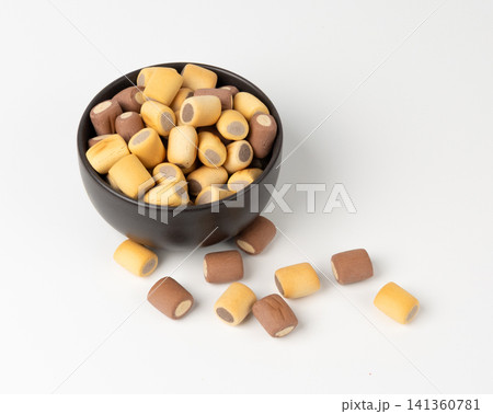 Filled dog biscuits, crackers isolated, soft crunchy pet treats pile, flavored small canine cookie Filled dog biscuits, crackers isolated, soft crunchy pet treats pile, flavored small canine cookie 141360781