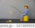 Happy child playing indoor. Kid enjoying a fishing trip. Little boy having fun at home 141360928