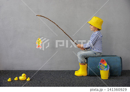Happy child playing indoor. Kid enjoying a fishing trip. Little boy having fun at home Happy child playing indoor. Kid enjoying a fishing trip. Little boy having fun at home 141360929