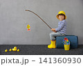 Happy child playing indoor. Kid enjoying a fishing trip. Little boy having fun at home 141360930