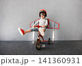 Happy child pretend to be astronaut. Funny kid with paper rocket. Little boy playing indoors 141360931