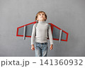 Happy child pretend to be astronaut. Funny kid with paper rocket. Little boy playing indoors 141360932