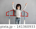 Happy child pretend to be astronaut. Funny kid with paper rocket. Little boy playing indoors 141360933