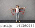 Happy child pretend to be astronaut. Funny kid with paper rocket. Little boy playing indoors 141360934