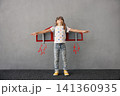 Happy child pretend to be astronaut. Funny kid with paper rocket. Little boy playing indoors 141360935