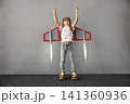 Happy child pretend to be astronaut. Funny kid with paper rocket. Little boy playing indoors 141360936