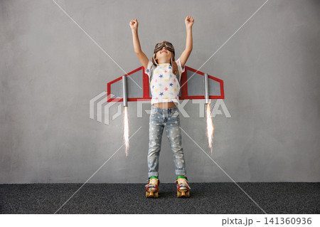 Happy child pretend to be astronaut. Funny kid with paper rocket. Little boy playing indoors 141360936