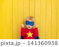 Little boy dressed as a superhero having fun at home 141360938