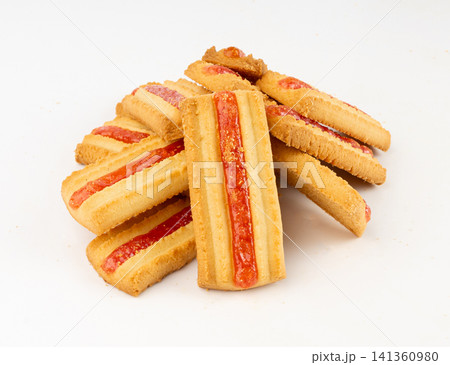Shortbread sticks with a jam strip isolated, biscuit cookies with fruit marmalade or jelly on white 141360980