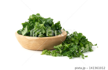 Pieces of kale cabbage leaves isolated. Green leaf of curly cabbage cooked for fresh salad Pieces of kale cabbage leaves isolated. Green leaf of curly cabbage cooked for fresh salad 141361012