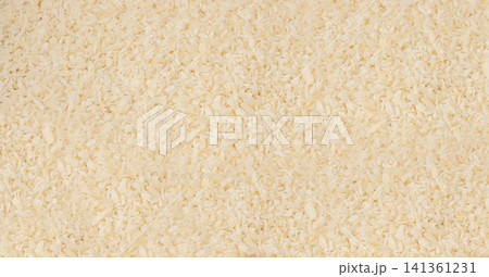 Grated coconut powder. Dry coco flakes pile, shredded desiccated coconut, tropical fruit chips 141361231