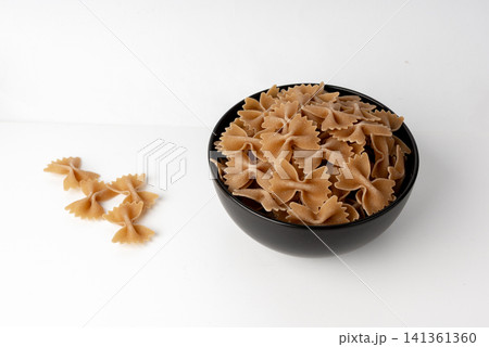 Raw Brown Farfalle Pasta Isolated Raw Brown Farfalle Pasta Isolated 141361360